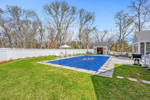 a view of yard with swimming pool and seating