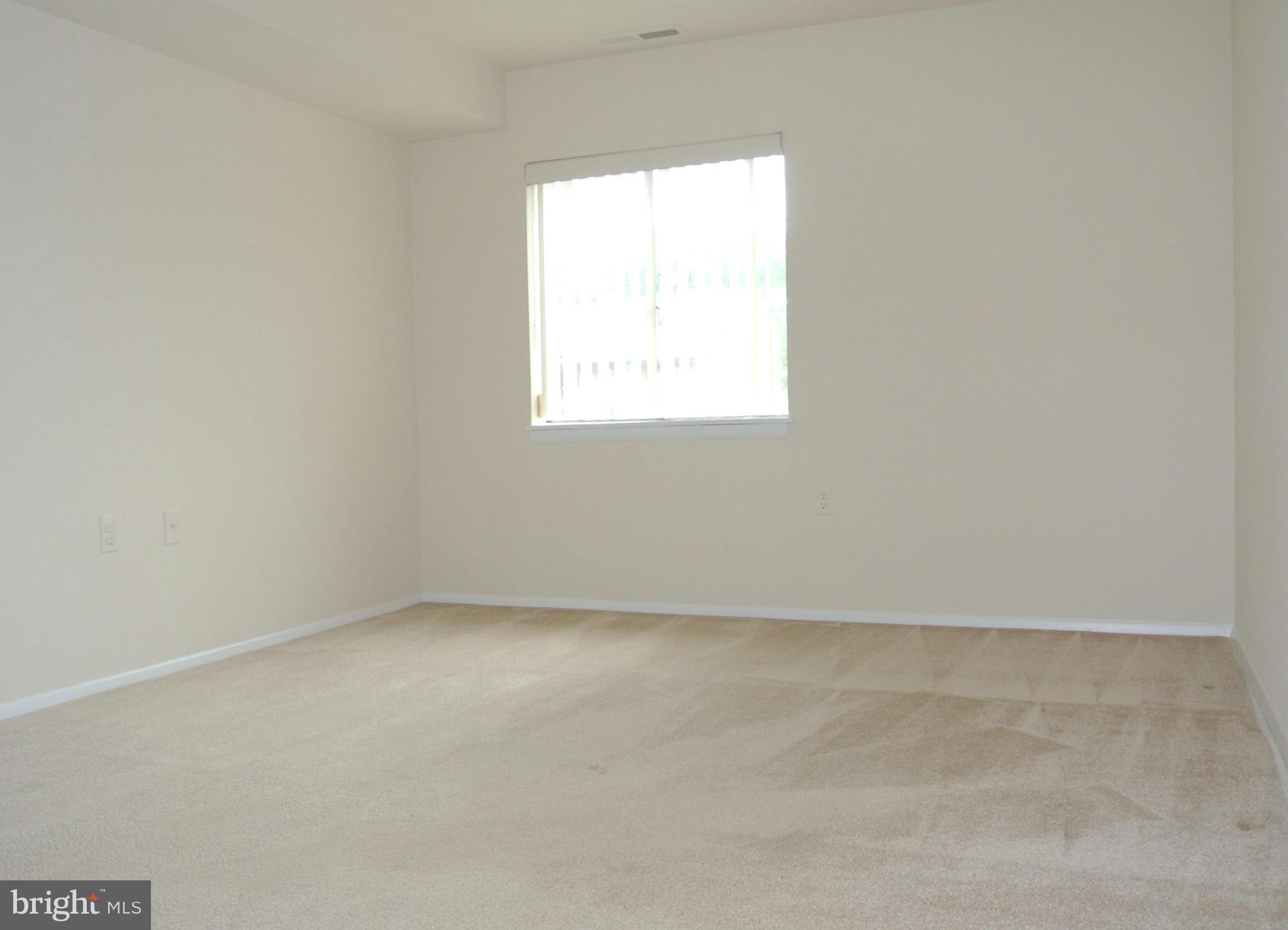 18712 Walkers Choice Road, Unit 4 Montgomery Village, MD 20886 - Photo 12 of 15 an empty room with a window