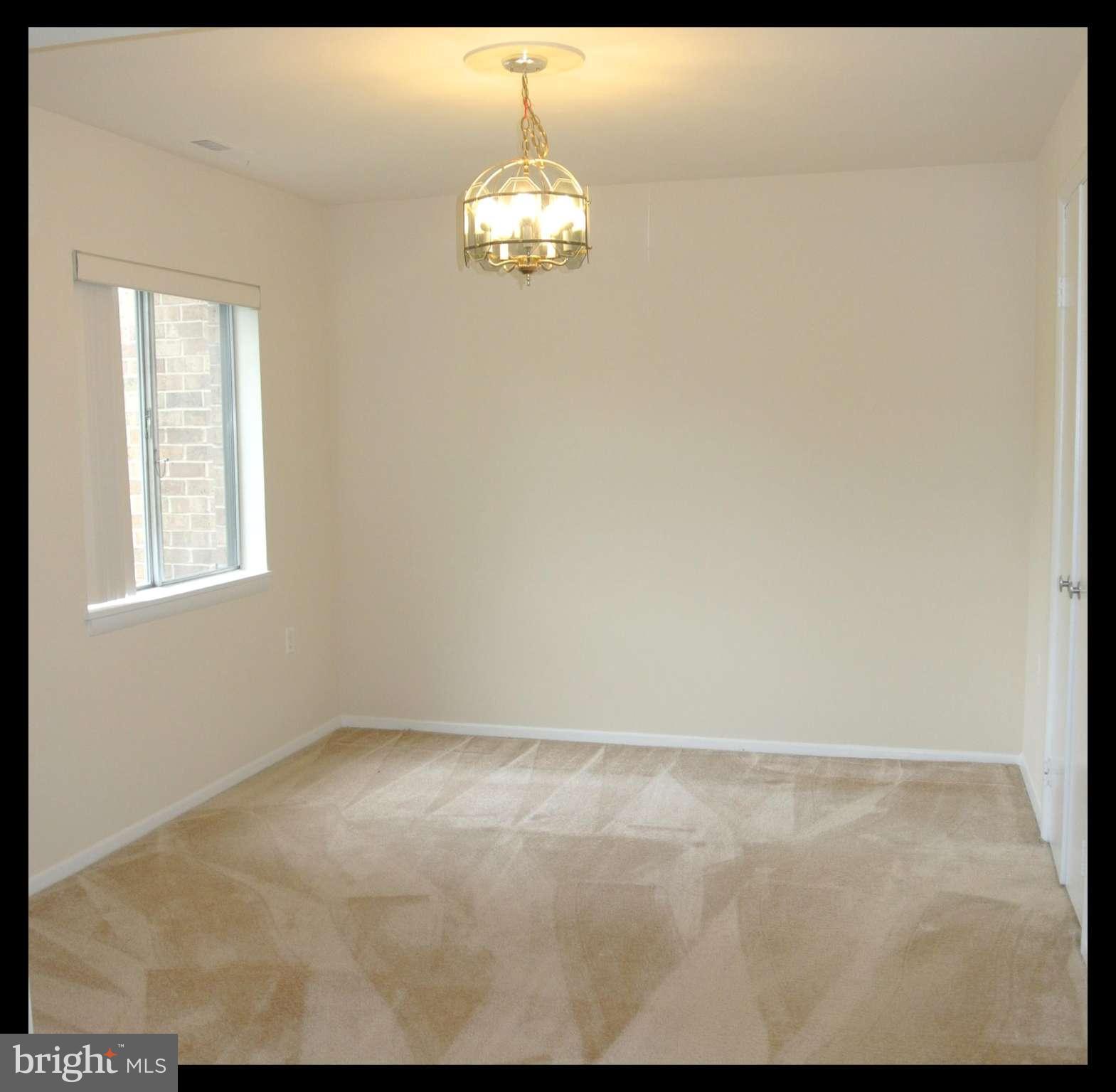 18712 Walkers Choice Road, Unit 4 Montgomery Village, MD 20886 - Photo 6 of 15 a view of wooden floor and chandelier in a room