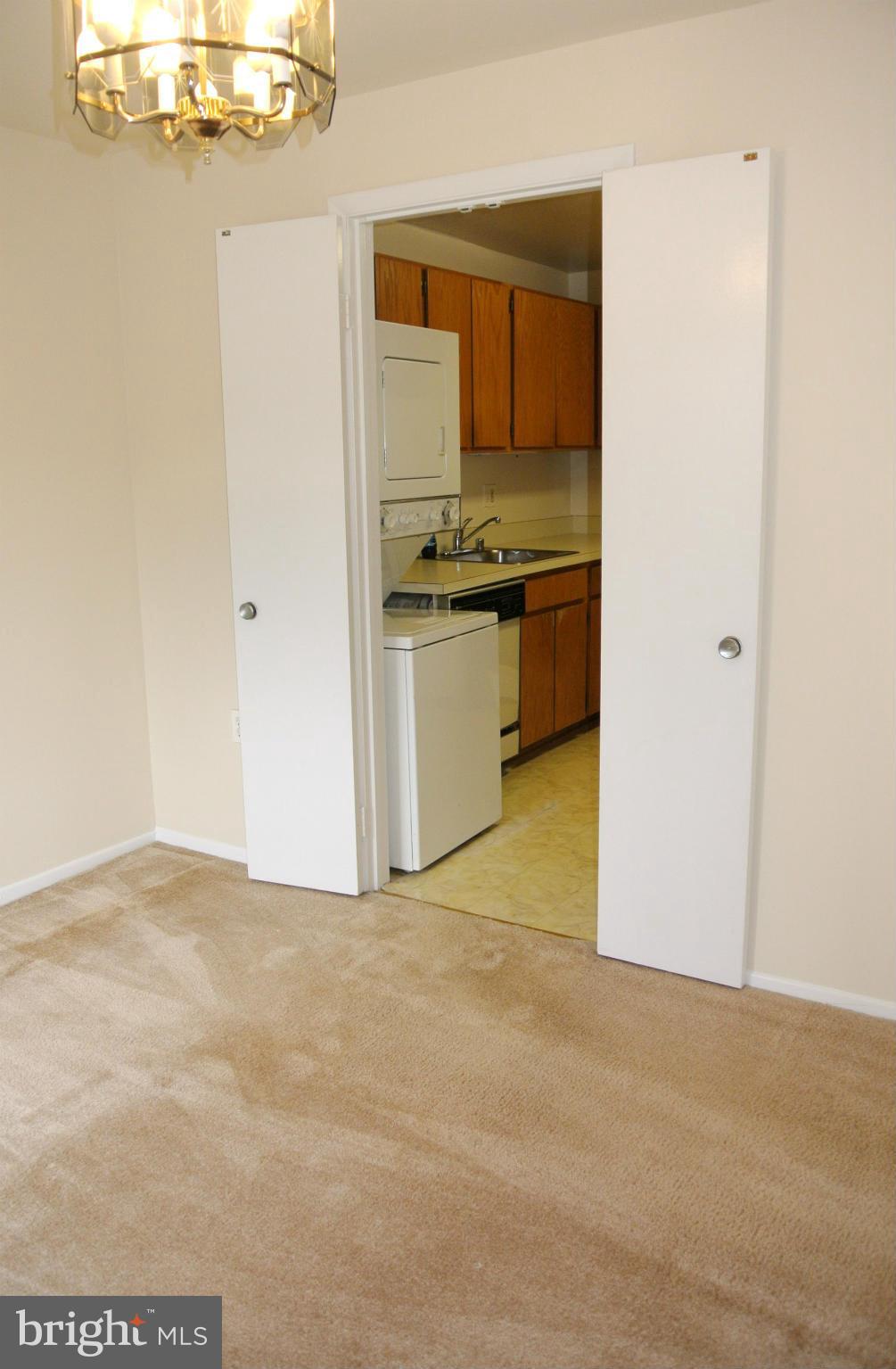 18712 Walkers Choice Road, Unit 4 Montgomery Village, MD 20886 - Photo 7 of 15 a view of kitchen and empty room with wooden floor