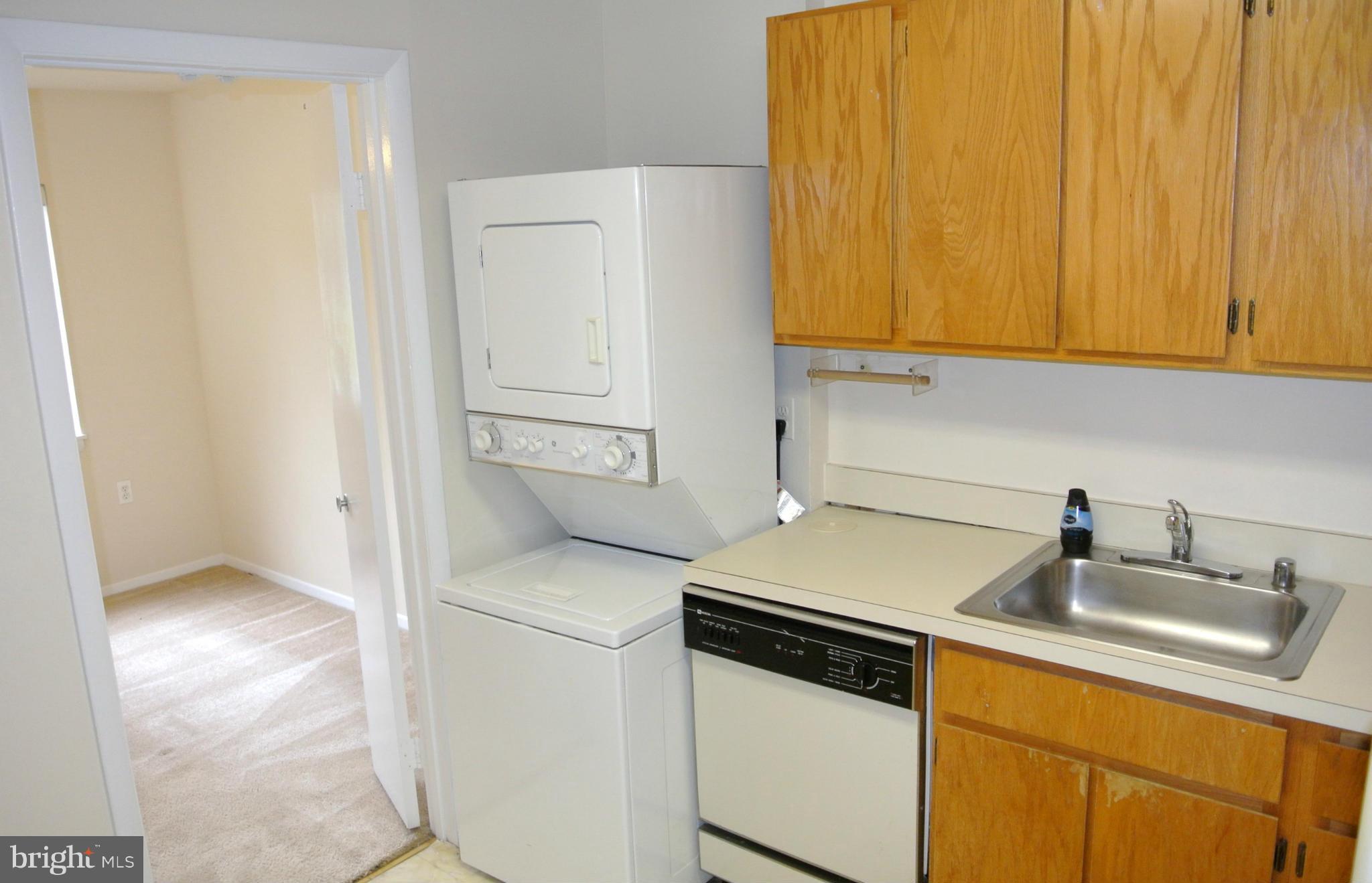 18712 Walkers Choice Road, Unit 4 Montgomery Village, MD 20886 - Photo 9 of 15 a kitchen with a sink and a refrigerator