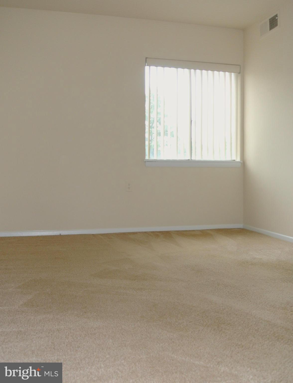 18712 Walkers Choice Road, Unit 4 Montgomery Village, MD 20886 - Photo 10 of 15 a view of an empty room with a window