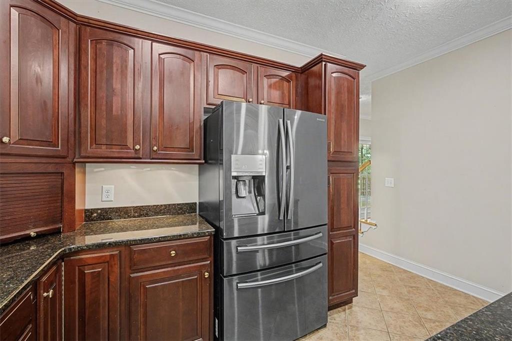 1136 Cole Lake Road Dallas, GA 30157 - Photo 23 of 72 a metallic refrigerator freezer sitting inside of a kitchen