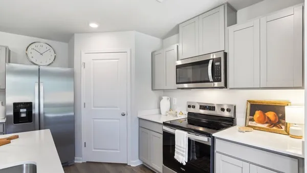 a kitchen with stainless steel appliances a stove microwave and refrigerator