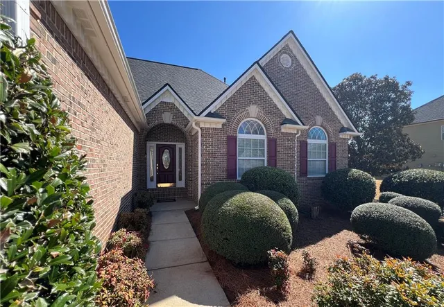 a front view of a house with garden