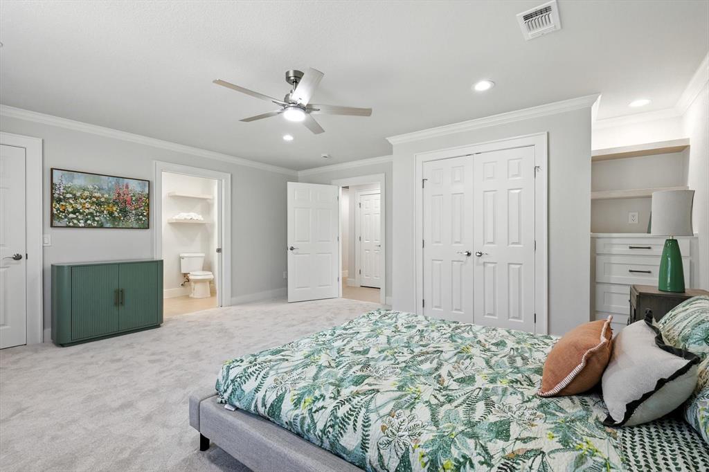 3901 Montecito Drive, Unit 1007 Denton, TX 76210 - Photo 12 of 24 a bedroom with a bed and a chandelier