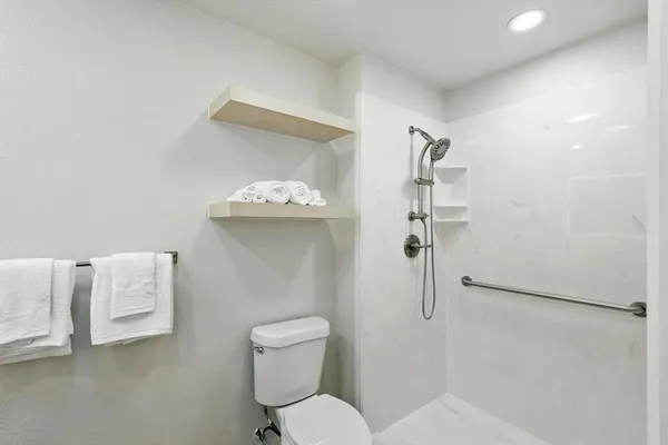 a white toilet sitting next to a bathroom sink