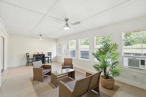 a living room with furniture potted plant and a window