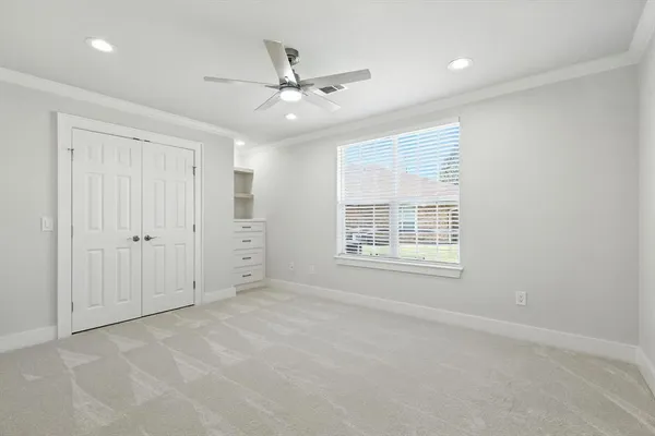 an empty room with fan and windows