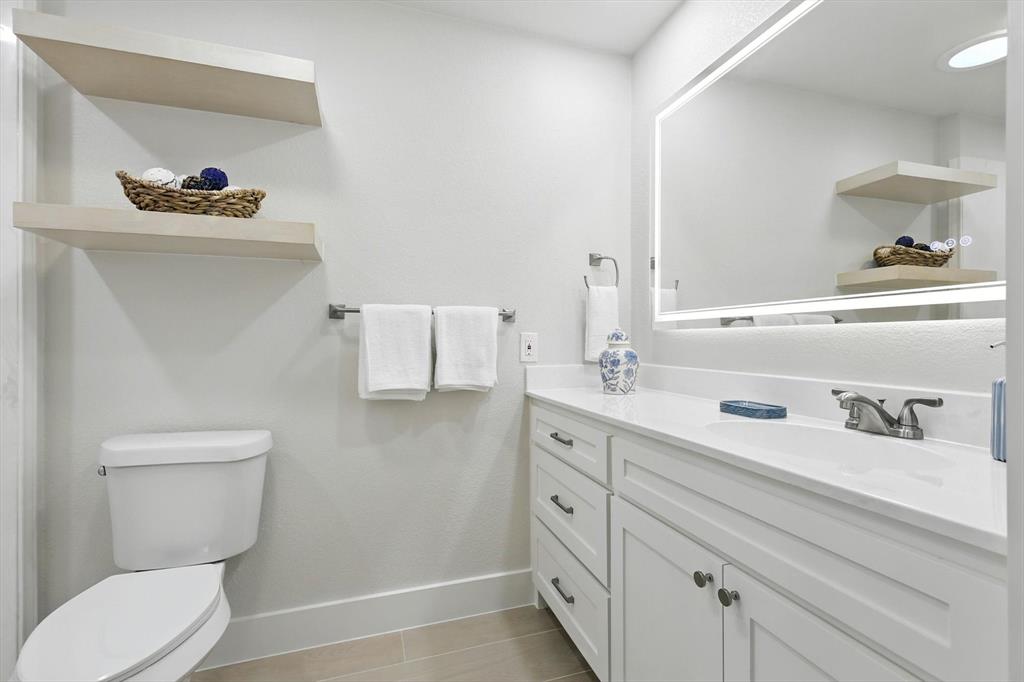 3901 Montecito Drive, Unit 1007 Denton, TX 76210 - Photo 18 of 24 a bathroom with a toilet sink and mirror