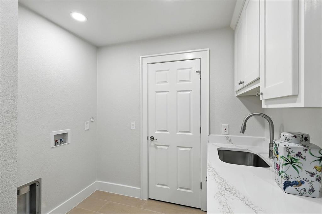 3901 Montecito Drive, Unit 1007 Denton, TX 76210 - Photo 19 of 24 a kitchen with a sink and cabinets