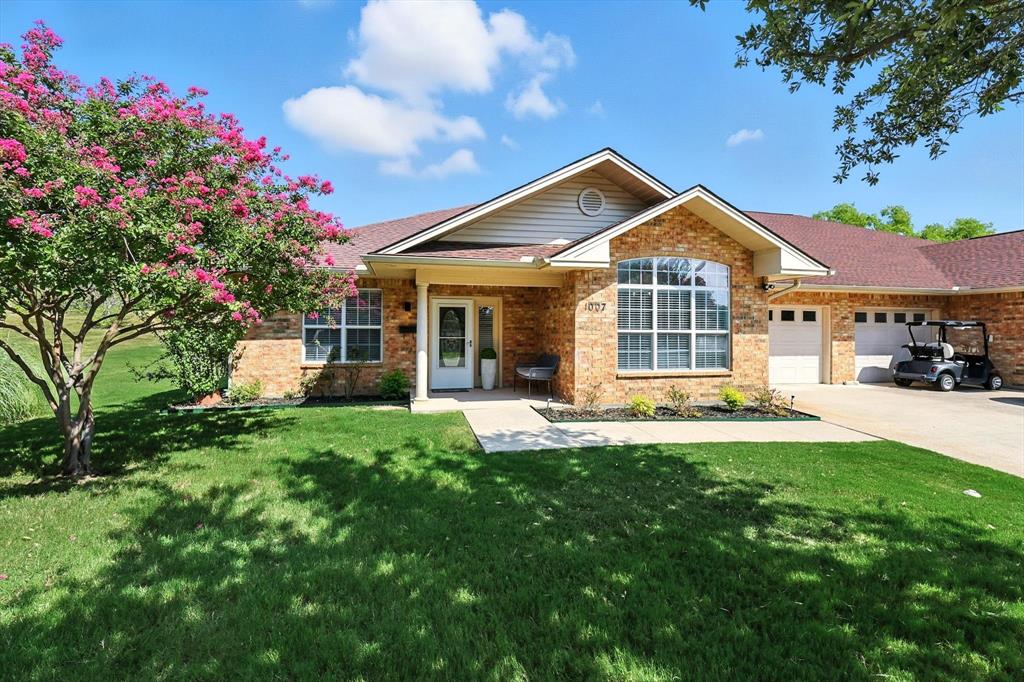 3901 Montecito Drive, Unit 1007 Denton, TX 76210 - Photo 21 of 24 a front view of a house with a yard