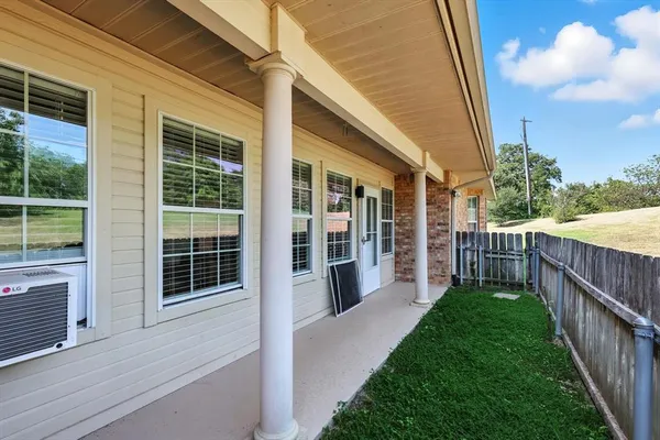 a view of a house with backyard and porch