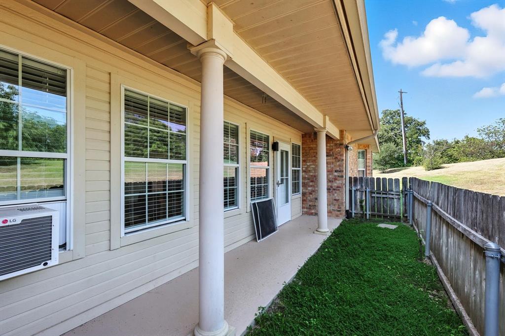 3901 Montecito Drive, Unit 1007 Denton, TX 76210 - Photo 22 of 24 a view of a house with backyard and porch