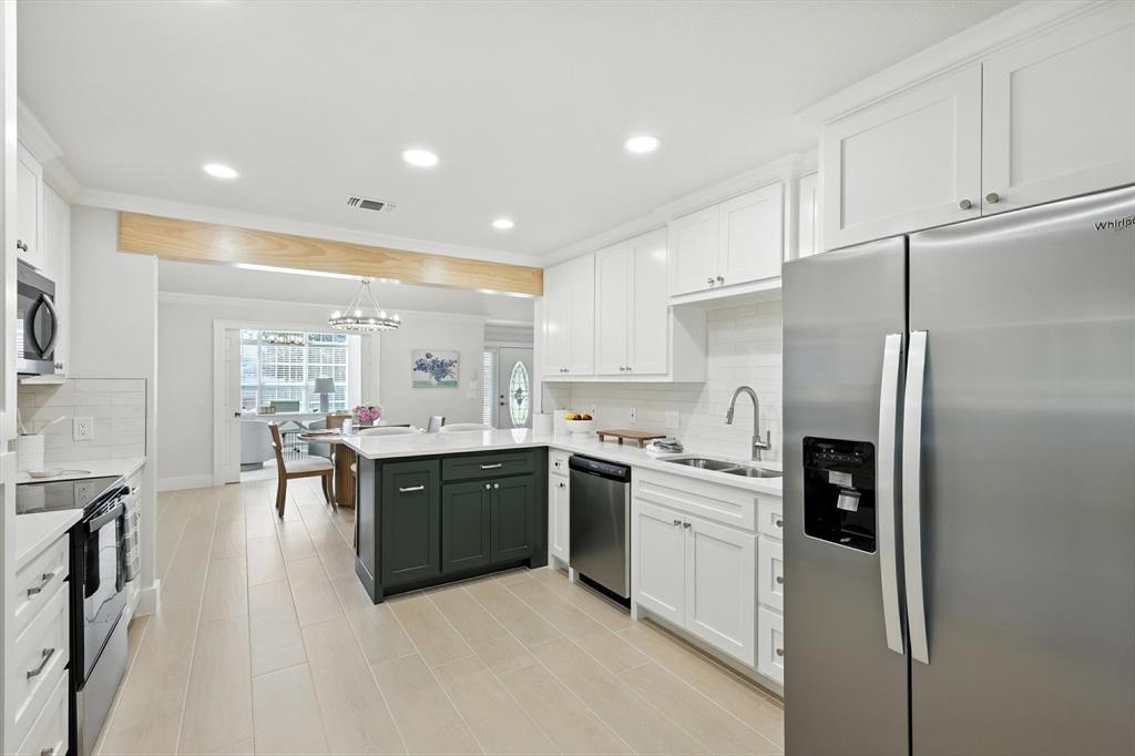 3901 Montecito Drive, Unit 1007 Denton, TX 76210 - Photo 6 of 24 a large kitchen with stainless steel appliances lots of counter space and breakfast area