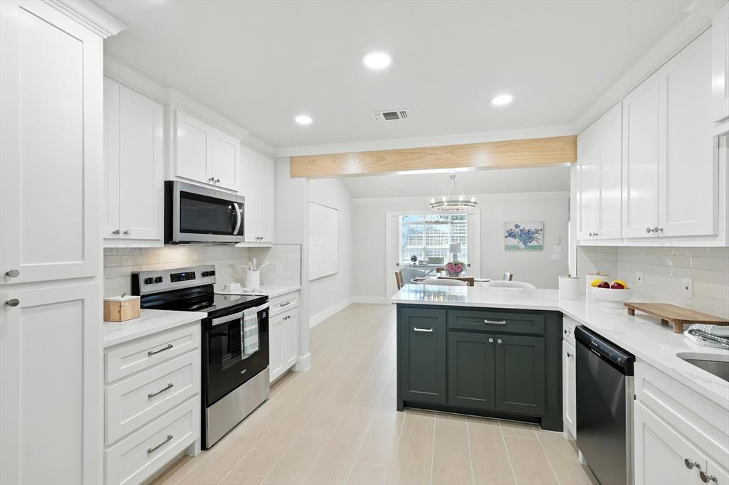 3901 Montecito Drive, Unit 1007 Denton, TX 76210 - Photo 7 of 24 a kitchen with stainless steel appliances kitchen island granite countertop a sink and cabinets