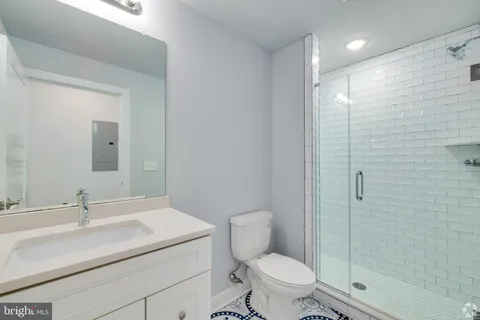 a bathroom with a sink toilet and shower