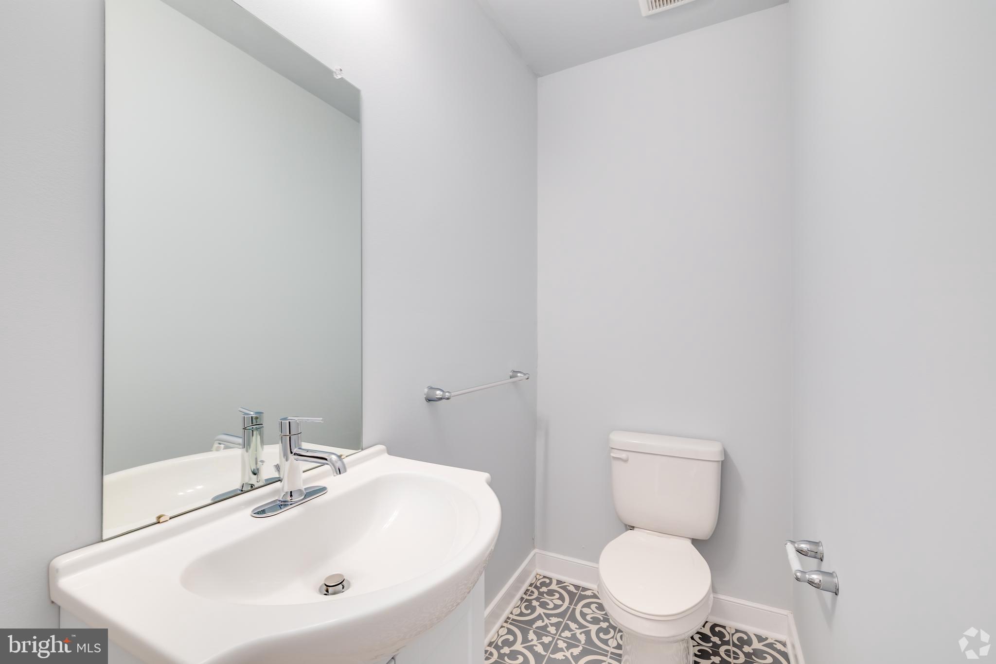 6090 Drexel Road, Unit 4 Philadelphia, PA 19131 - Photo 16 of 18 a bathroom with a sink a toilet and a mirror