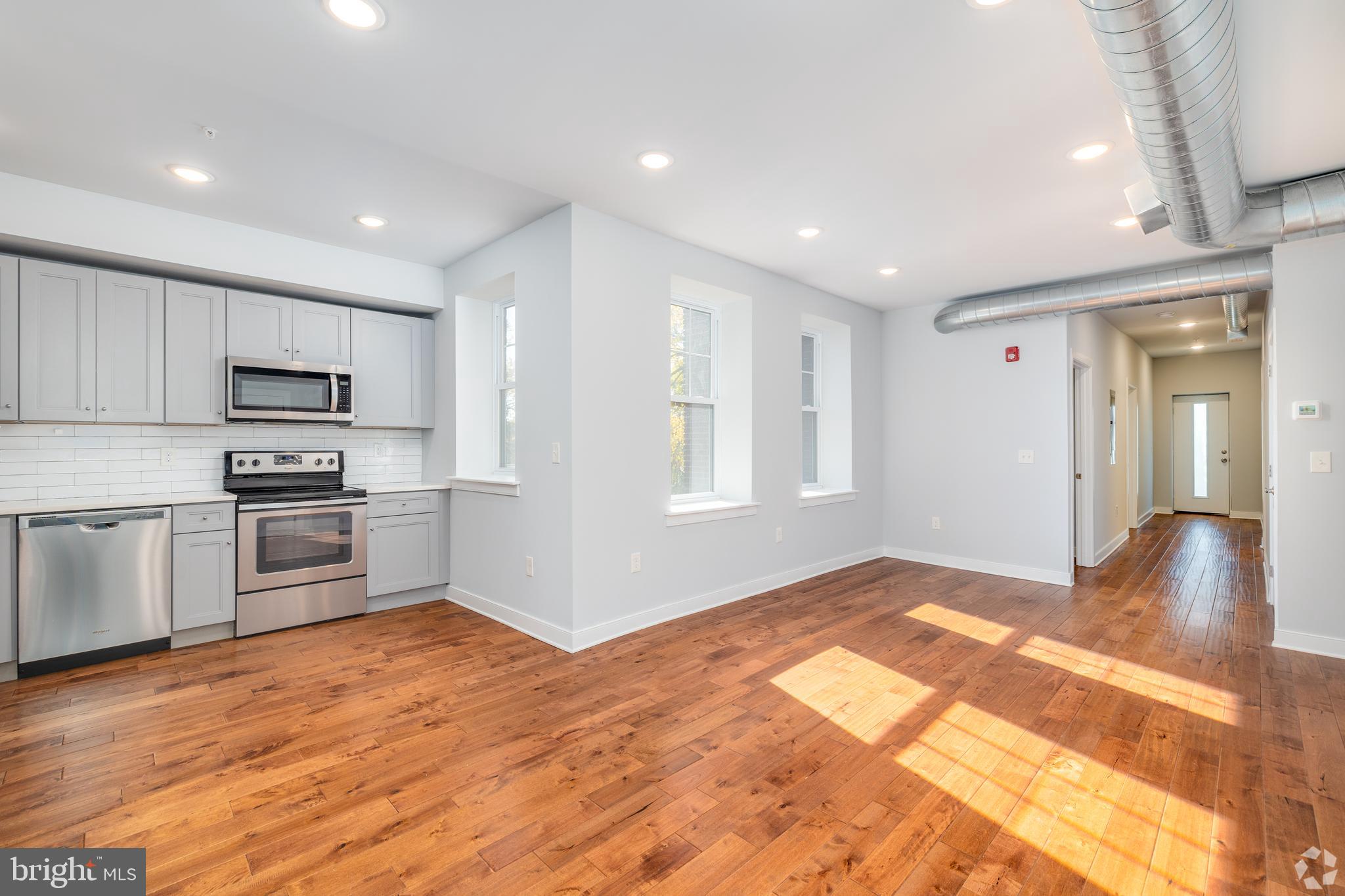 6090 Drexel Road, Unit 4 Philadelphia, PA 19131 - Photo 6 of 18 a view of a kitchen with microwave and cabinets