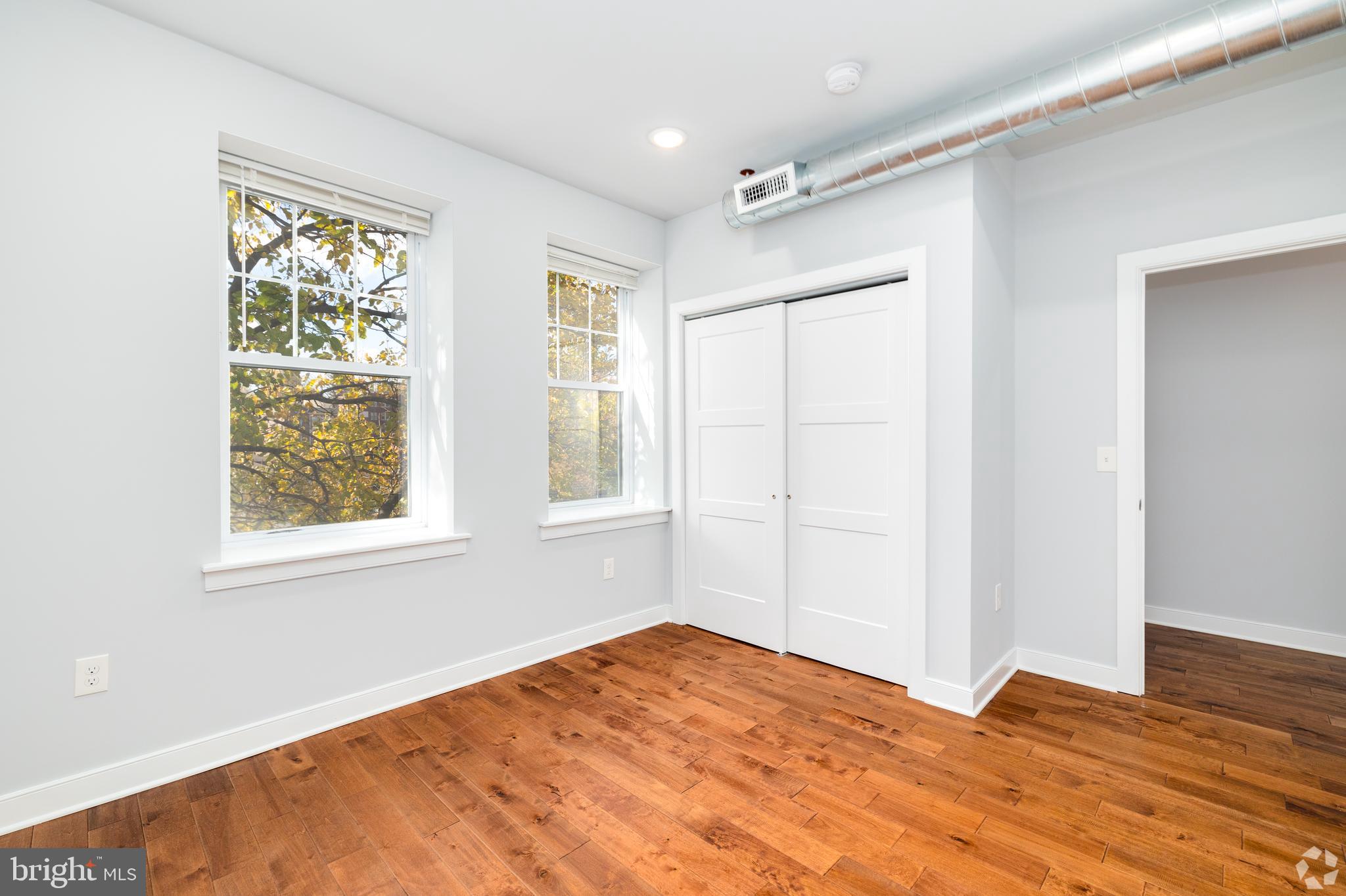 6090 Drexel Road, Unit 4 Philadelphia, PA 19131 - Photo 10 of 18 a view of an empty room with wooden floor and a window