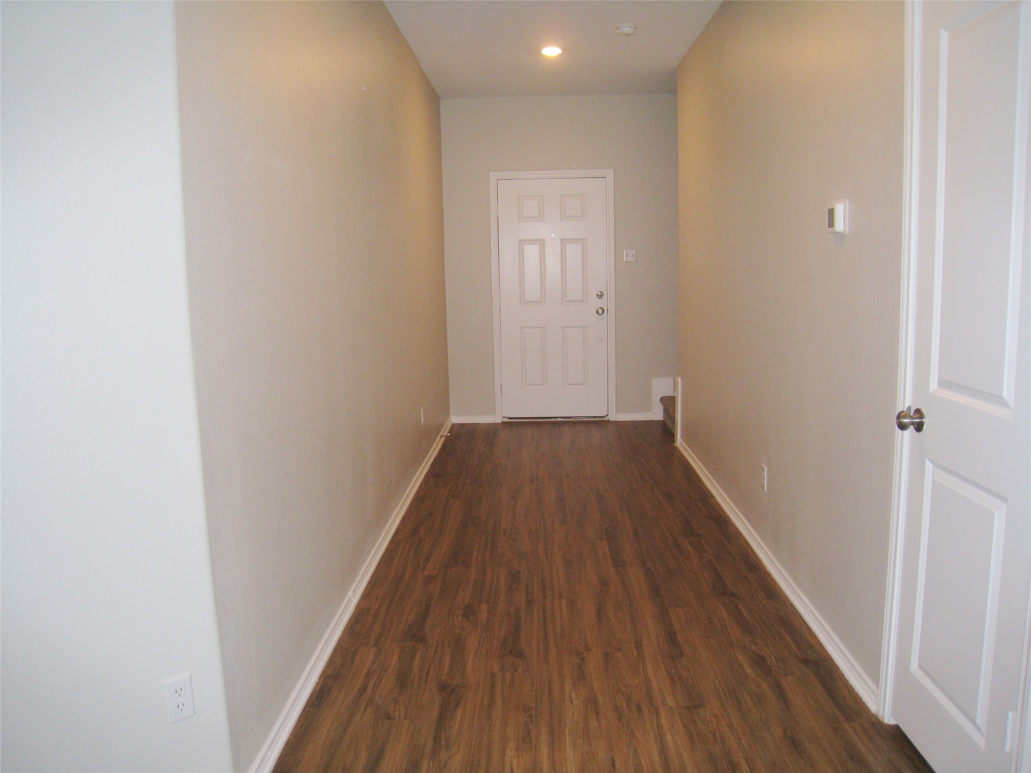 229 Geode Glen Maxwell, TX 78656 - Photo 8 of 19 A well-lit entry hall with wood-look flooring creates a welcoming first impression.