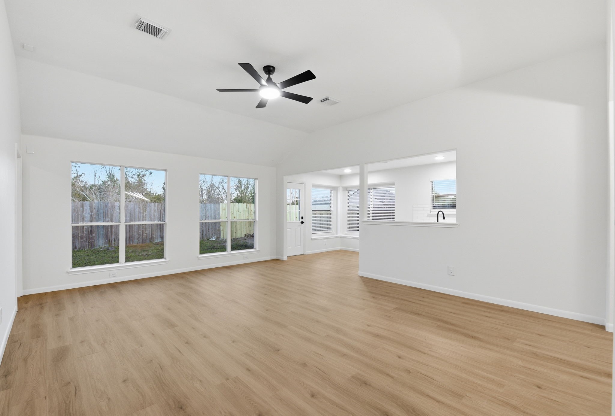 4426 Kulkarni Street Houston, TX 77045 - Photo 11 of 33 a view of an empty room with wooden floor and a window