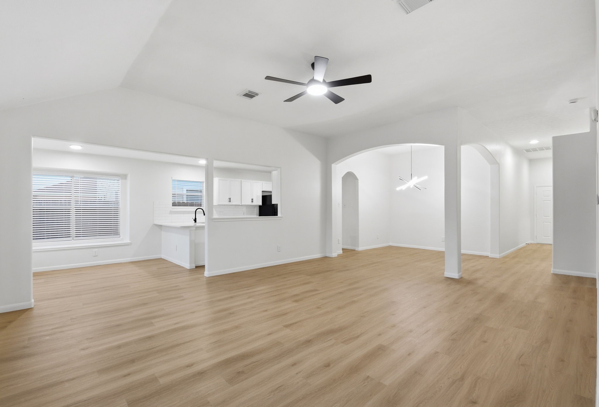 4426 Kulkarni Street Houston, TX 77045 - Photo 12 of 33 a view of a livingroom with a ceiling fan window and wooden floor