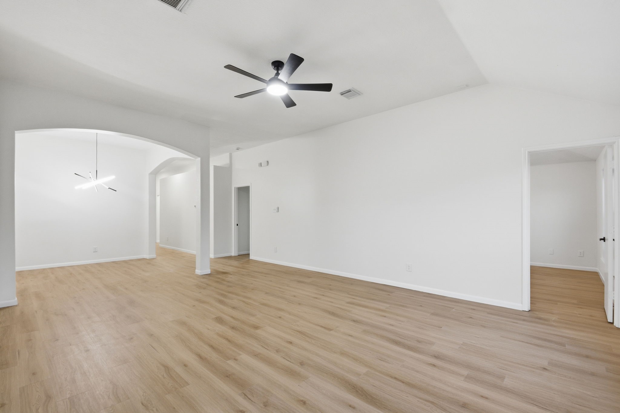 4426 Kulkarni Street Houston, TX 77045 - Photo 13 of 33 a view of an empty room with wooden floor