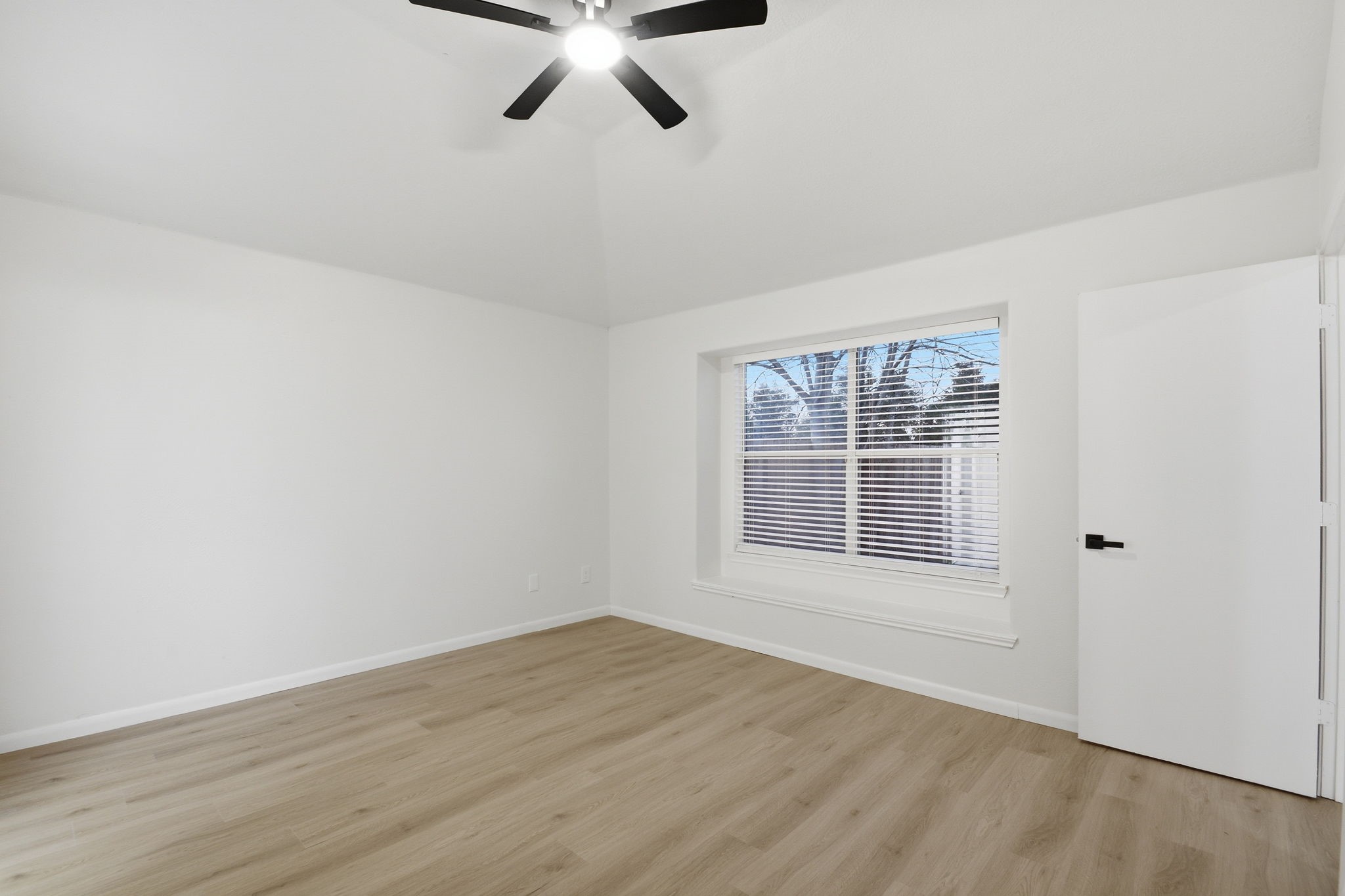 4426 Kulkarni Street Houston, TX 77045 - Photo 21 of 33 an empty room with wooden floor and windows