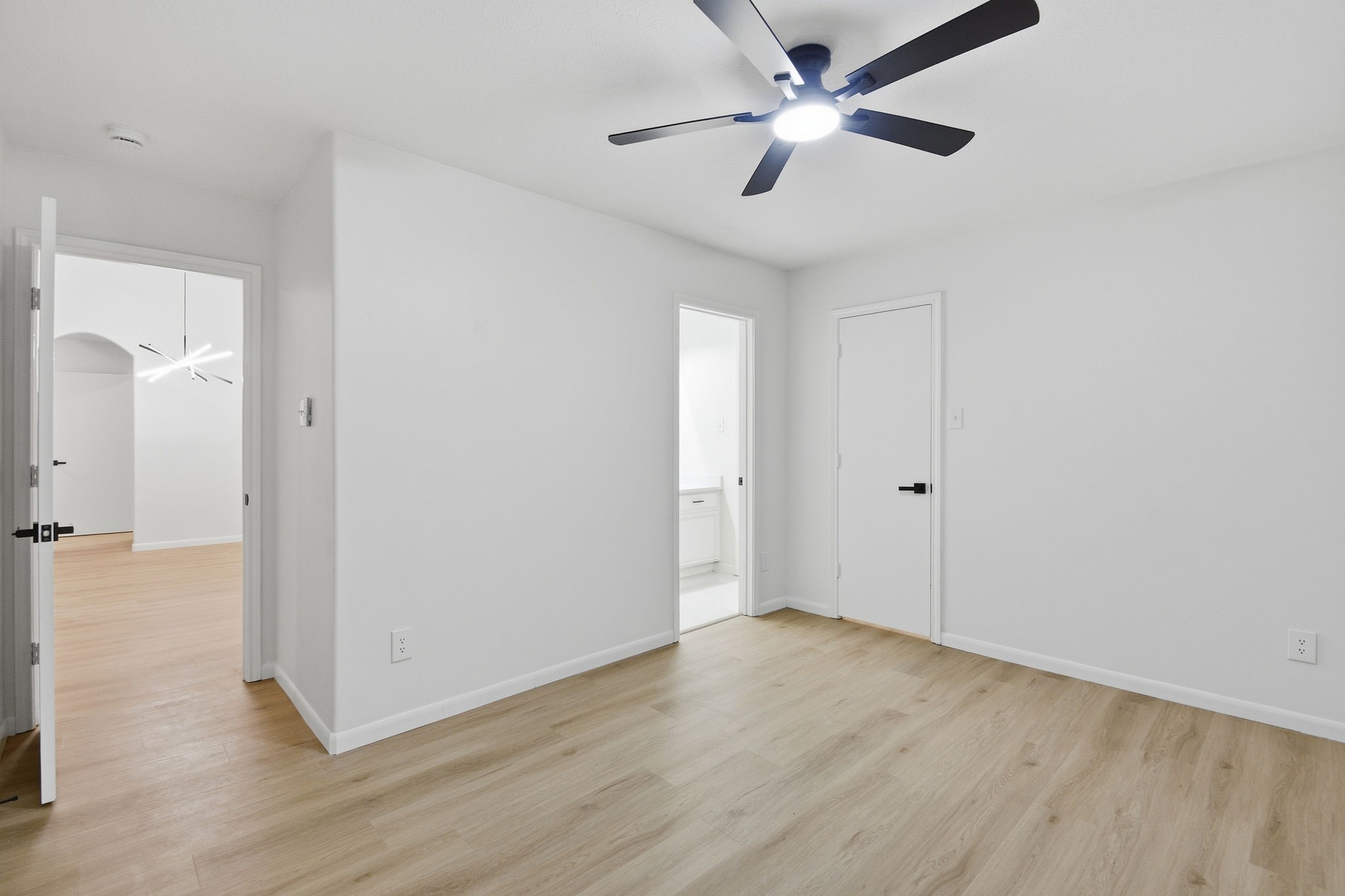 4426 Kulkarni Street Houston, TX 77045 - Photo 23 of 33 an empty room with wooden floor and a ceiling fan