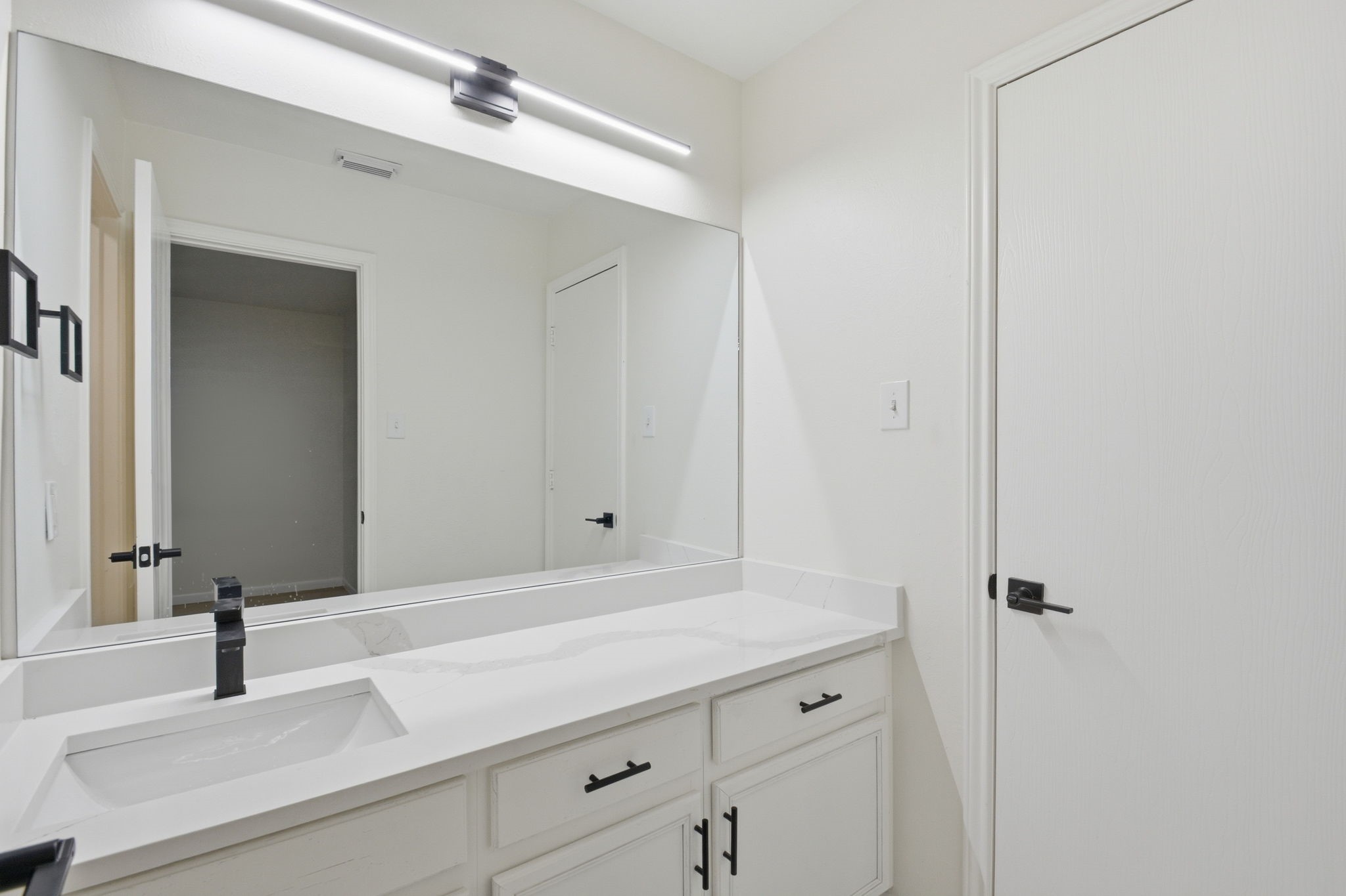 4426 Kulkarni Street Houston, TX 77045 - Photo 24 of 33 a bathroom with a granite countertop sink and a mirror