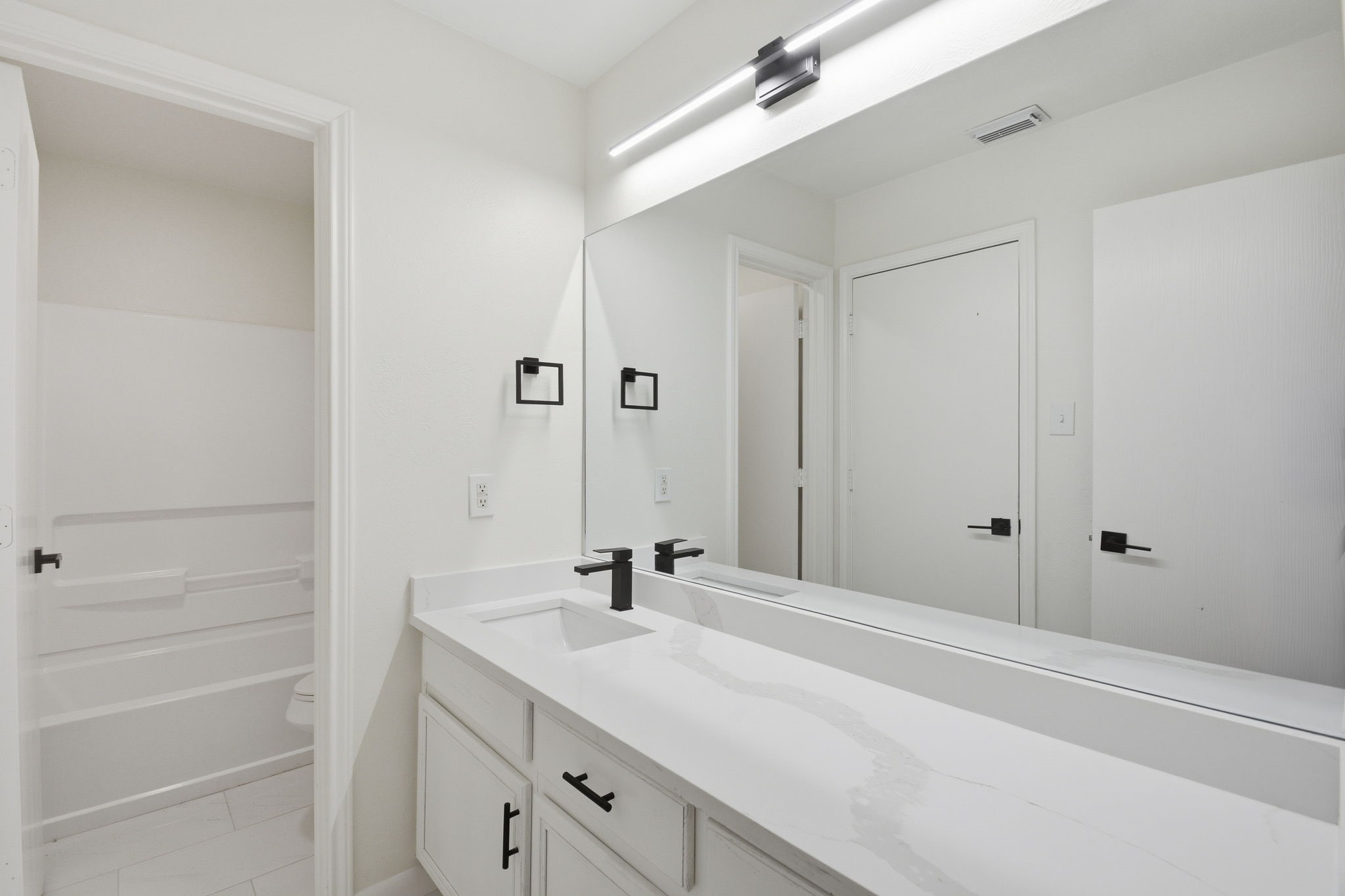 4426 Kulkarni Street Houston, TX 77045 - Photo 25 of 33 a bathroom with a sink and a mirror