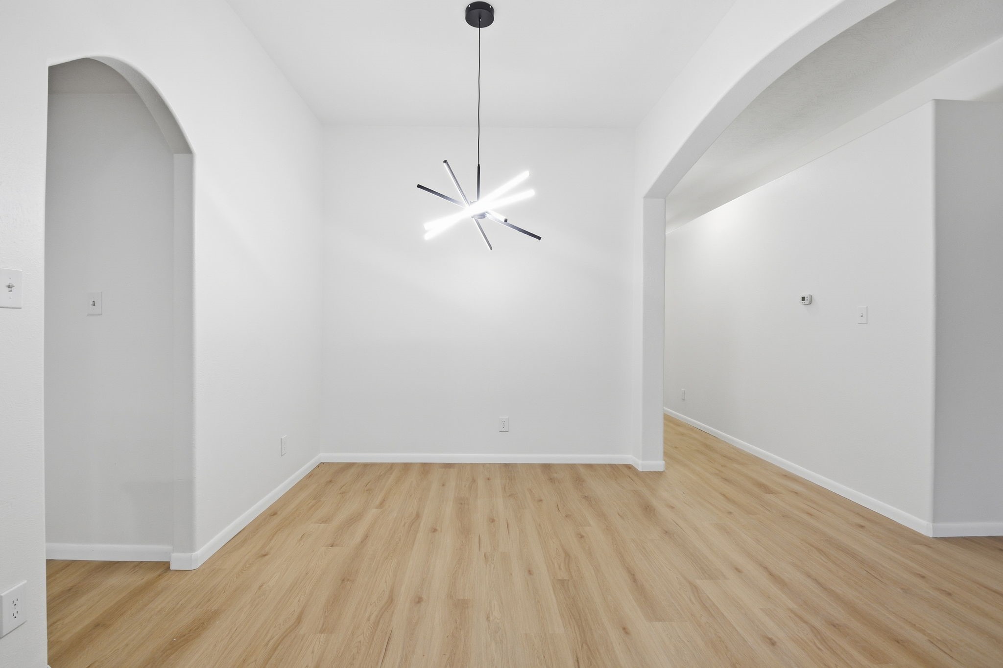 4426 Kulkarni Street Houston, TX 77045 - Photo 9 of 33 a view of a room with wooden floor