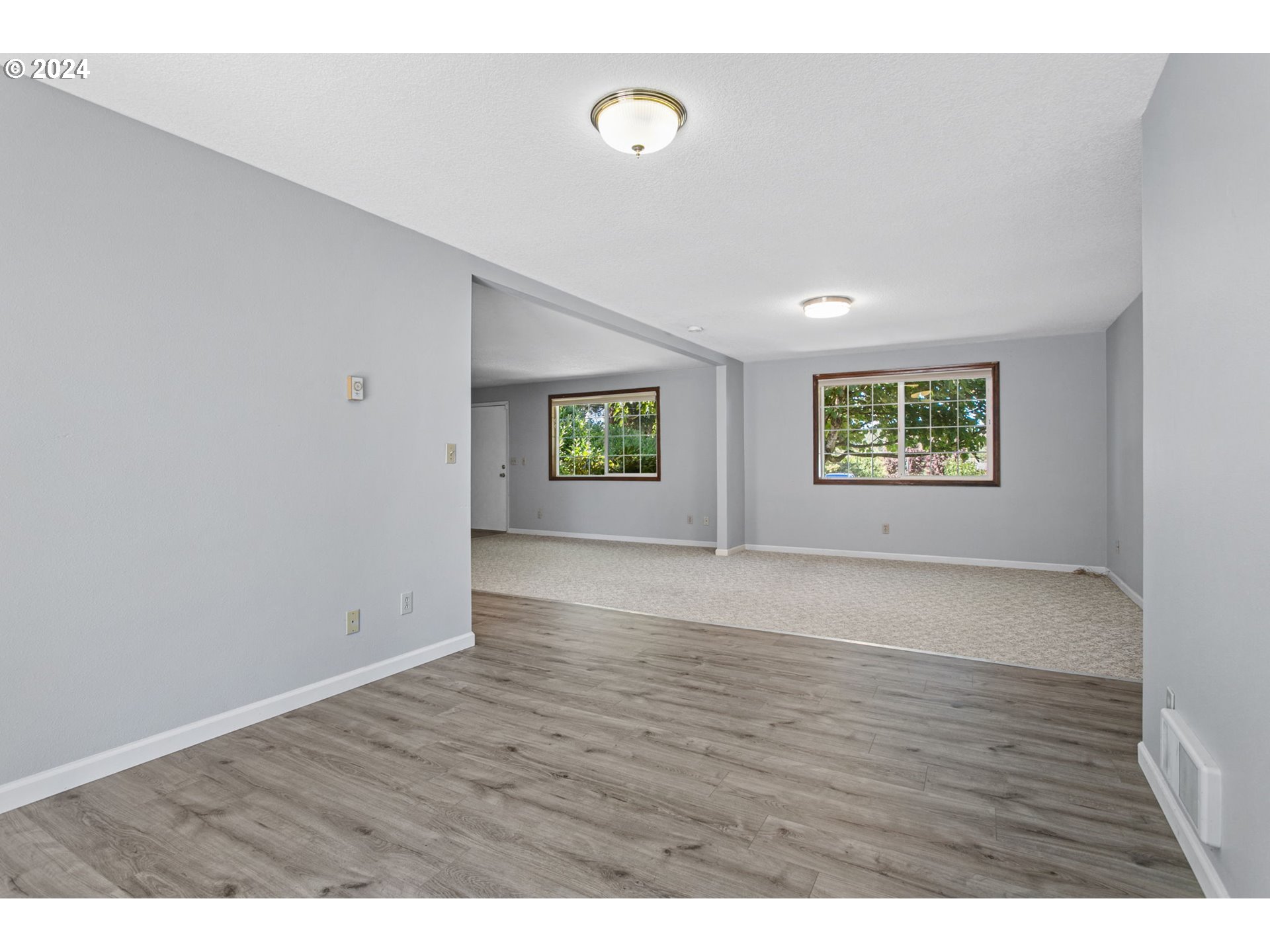 1215 Northwest 189th Street Ridgefield, WA 98642 - Photo 15 of 31 a view of an empty room with a window and wooden floor