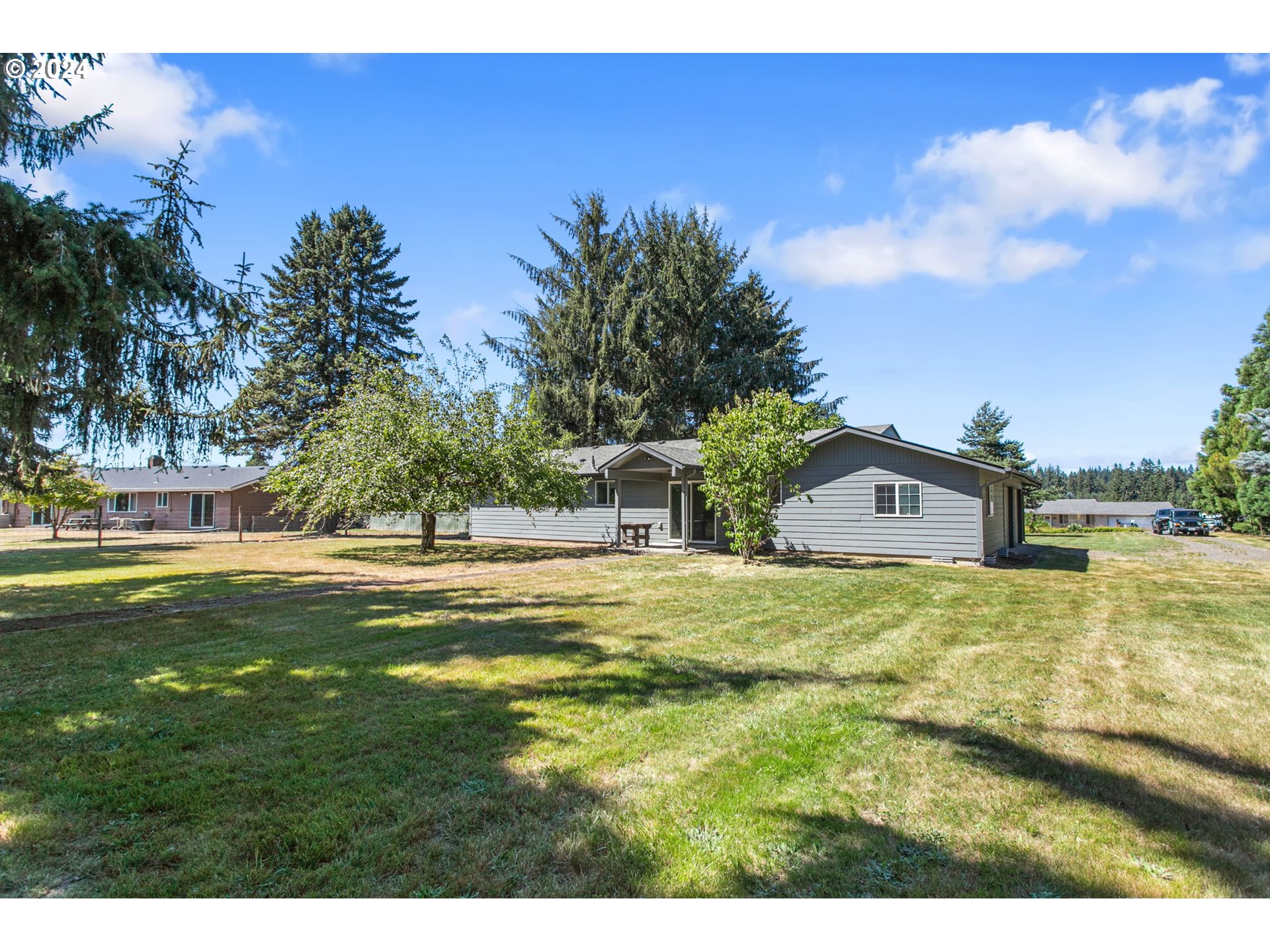 1215 Northwest 189th Street Ridgefield, WA 98642 - Photo 3 of 31 a view of big house with a big yard and large trees