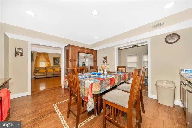 a kitchen with stainless steel appliances kitchen island granite countertop a table and chairs