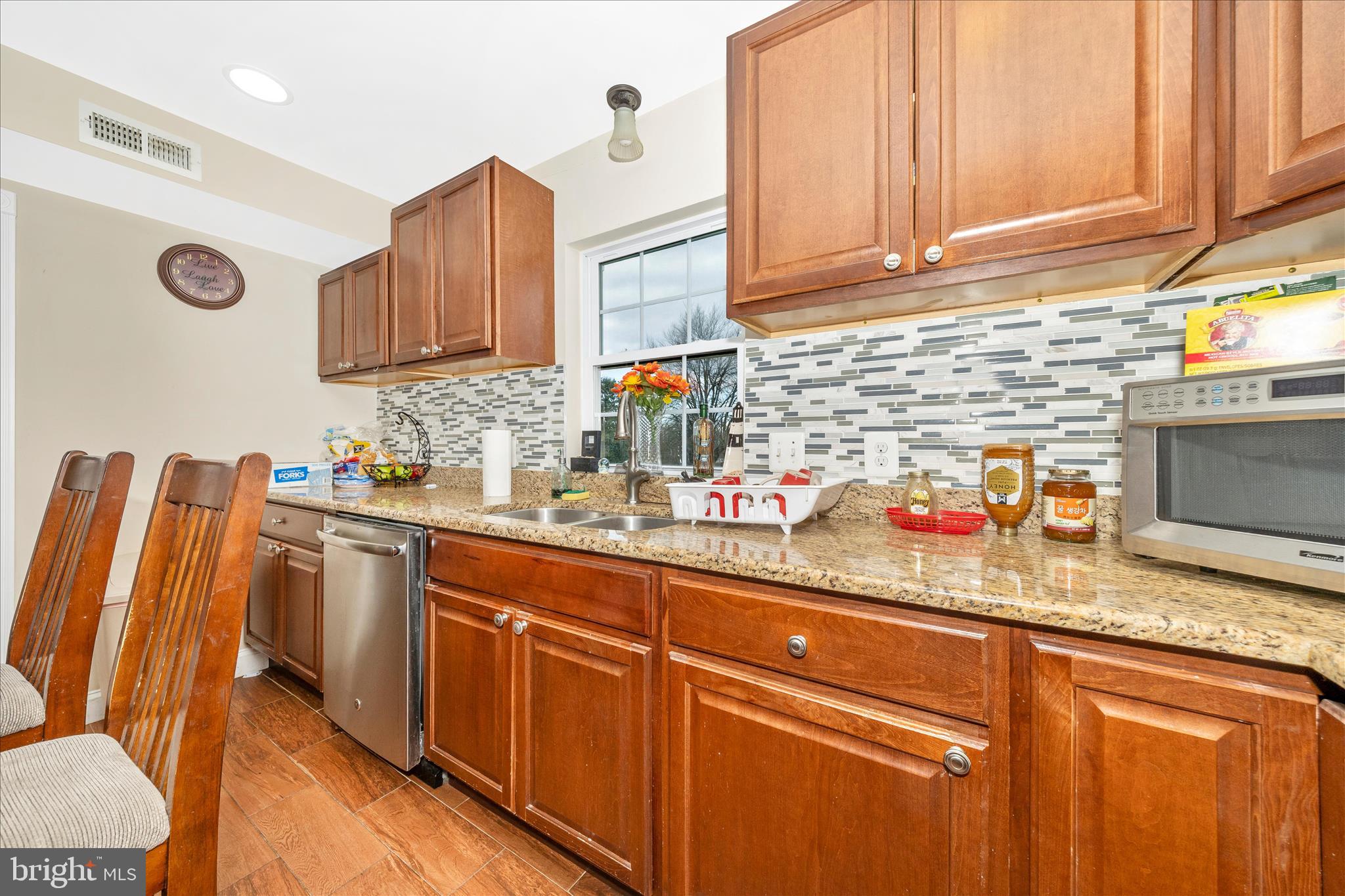 9507 Main Street Damascus, MD 20872 - Photo 22 of 51 a kitchen with stainless steel appliances granite countertop a sink and cabinets