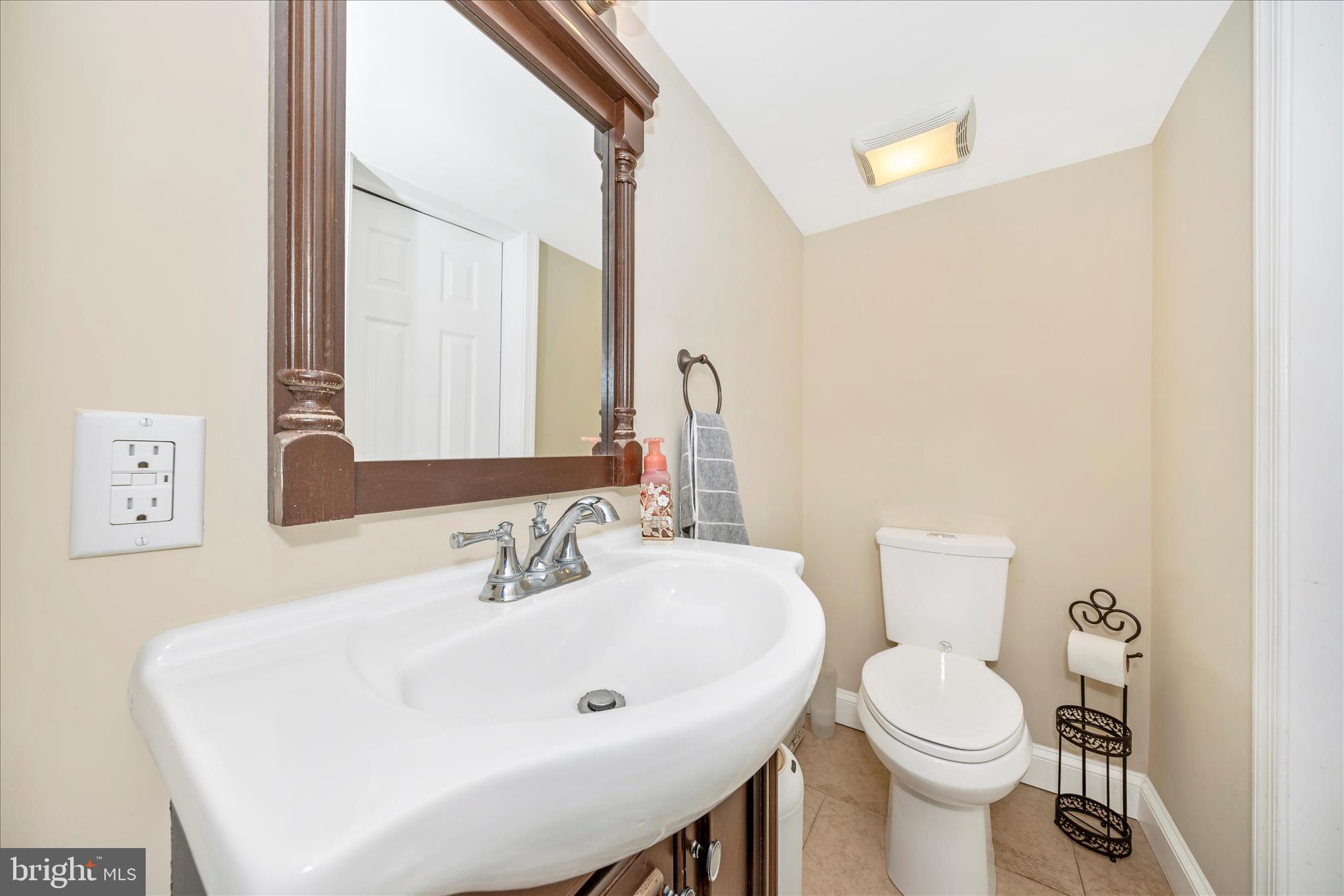 9507 Main Street Damascus, MD 20872 - Photo 24 of 51 a bathroom with a sink a toilet and mirror
