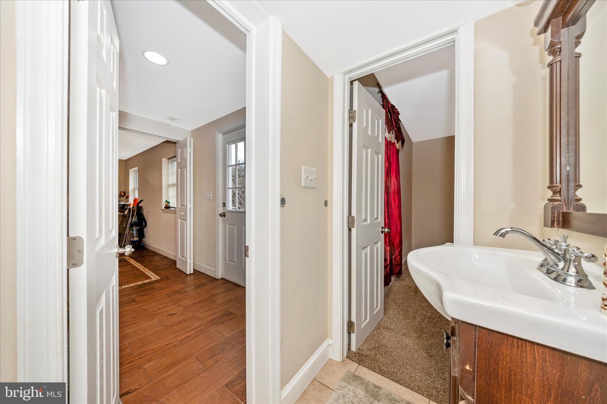 9507 Main Street Damascus, MD 20872 - Photo 25 of 51 a en suite bathroom with a sink and a mirror