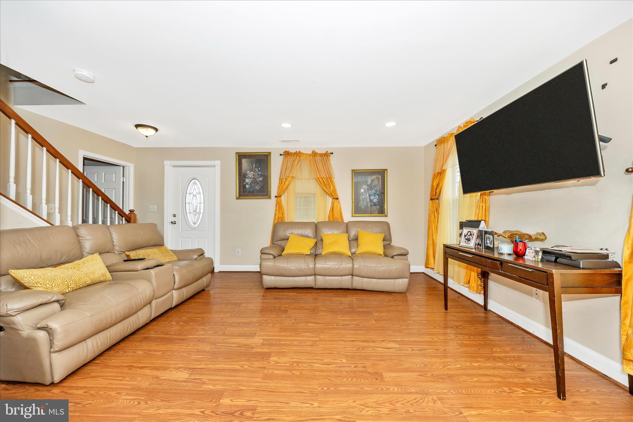 9507 Main Street Damascus, MD 20872 - Photo 29 of 51 a living room with furniture and a flat screen tv