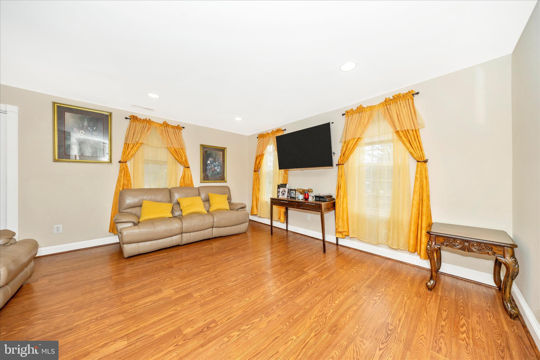 9507 Main Street Damascus, MD 20872 - Photo 30 of 51 a living room with furniture and a flat screen tv