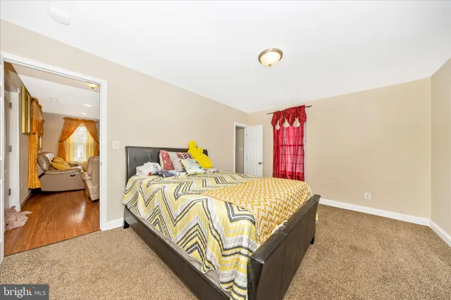 a bedroom with a bed and flat screen tv
