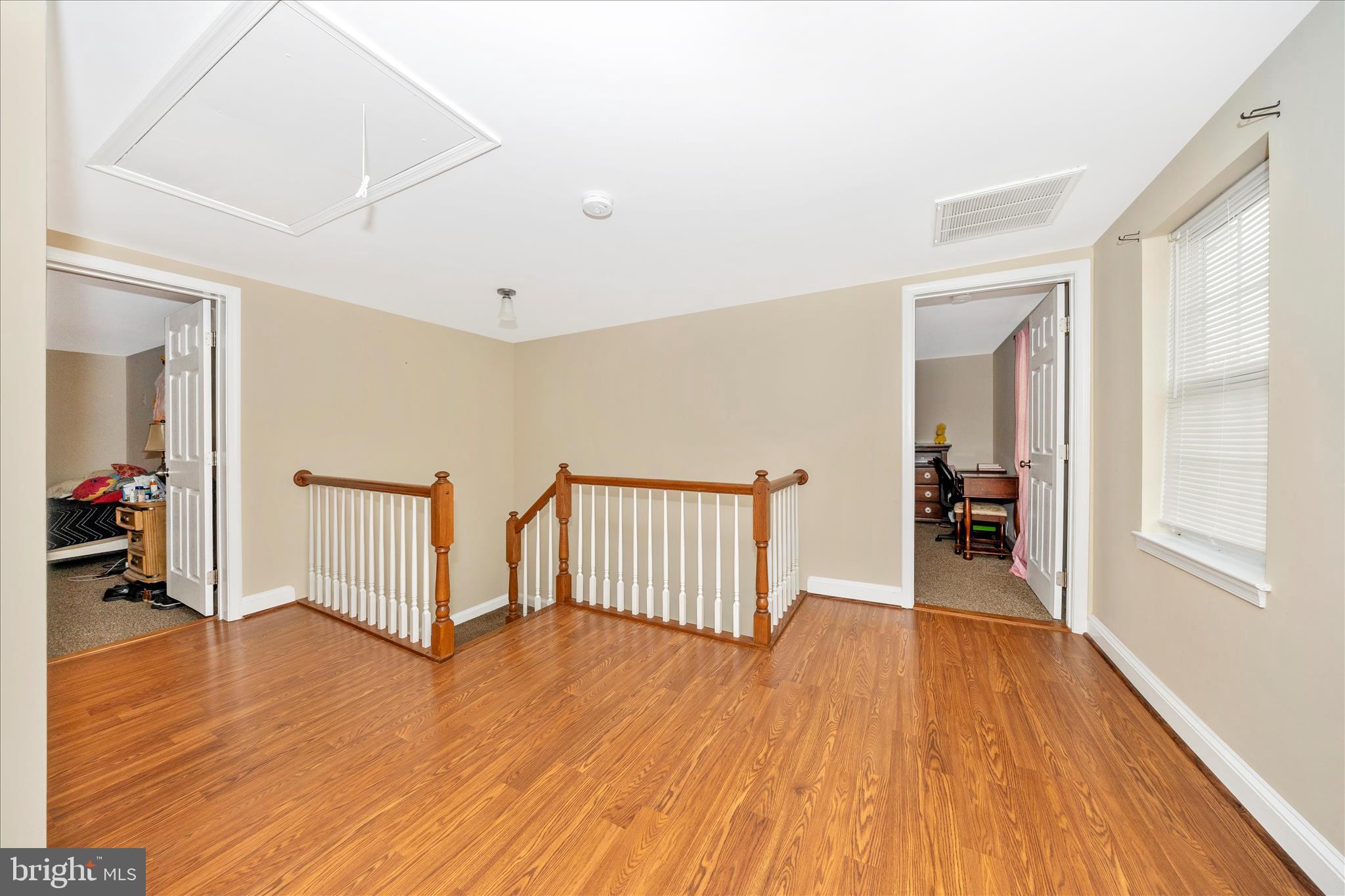 9507 Main Street Damascus, MD 20872 - Photo 39 of 51 a view of an empty room with wooden floor and a window