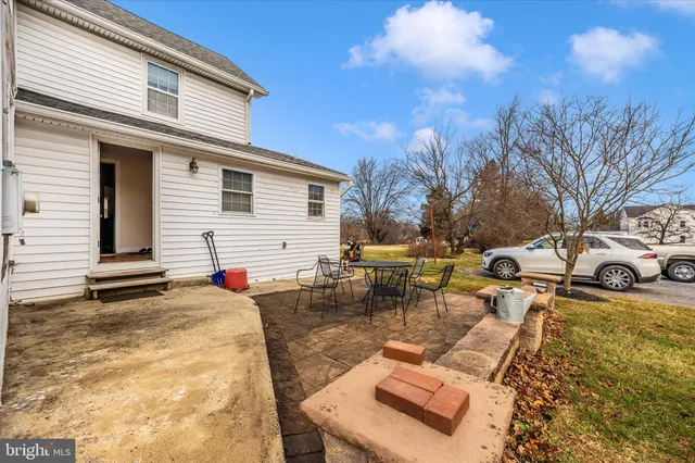 a view of a backyard with sitting area