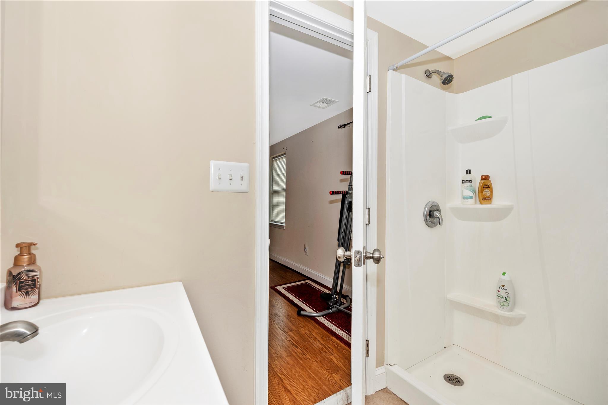 9507 Main Street Damascus, MD 20872 - Photo 41 of 51 a bathroom with a sink and a shower