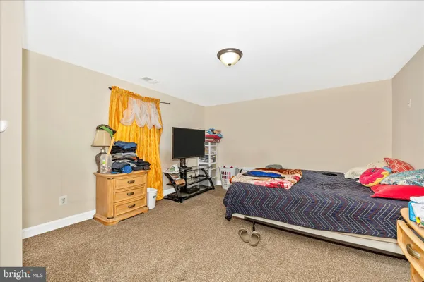 a bedroom with a bed and a dresser