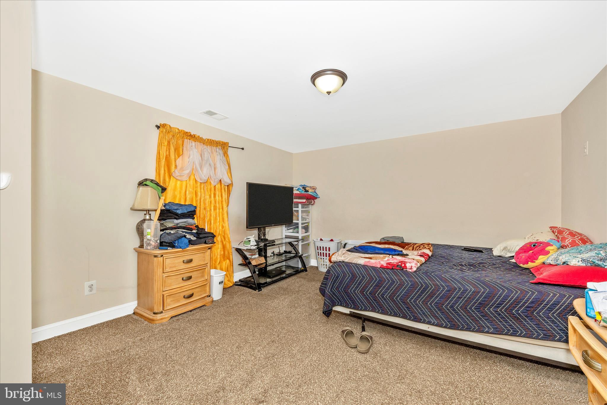 9507 Main Street Damascus, MD 20872 - Photo 42 of 51 a bedroom with furniture and a flat screen tv