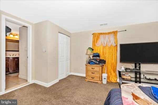 a bedroom with furniture and a flat screen tv