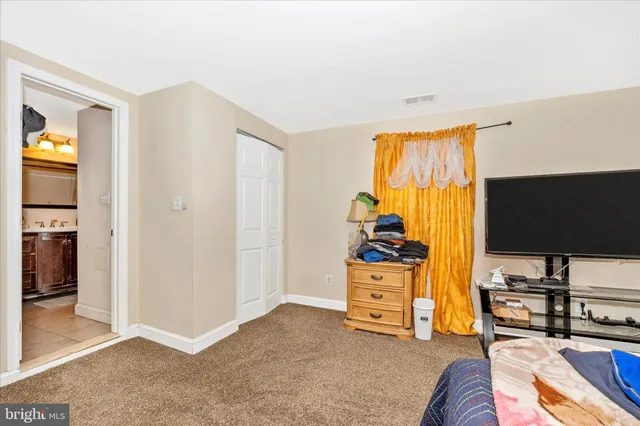 a bedroom with furniture and a flat screen tv