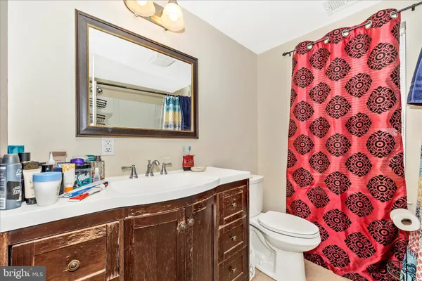 a bathroom with a sink a toilet and mirror